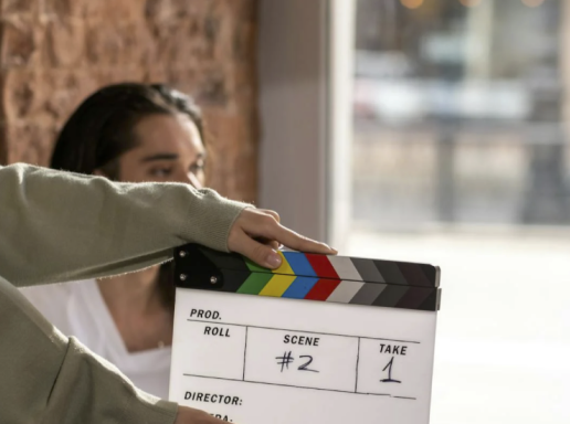 Woman holding clapperboard